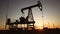 oil production. silhouette oil and gas production rig at sunset glare. oilfield business a extraction concept. lifestyle