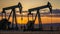 Oil Production at Sunset: Silhouette of Pumpjacks in a Desert Landscape