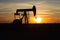 oil pump silhouette with a sunrise backdrop