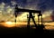 Oil pump on sunset background