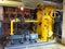 Oil pump, yellow pipes, tubes, machinery at power plant