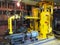 Oil pump, yellow pipes, tubes, machinery at power plant