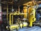 Oil pump, yellow pipes, tubes, machinery at power plant