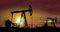 Oil pumps - oil extraction on sunset background