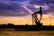 Oil pumps at oil field with sunset sky background