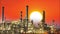 Oil refinery, factory with sun at sunset