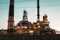 Oil refinery industrial plant or factory at sunset, storage distillery tanks and steel pipeline, modern petrochemical technologies