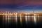 Oil refinery industry reflection on water at early morning under colorful sky of sunrise