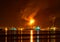 Oil refinery at night with a huge smoke column