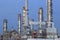 Oil refinery palnt against dusky blue sky in petrochemical indus