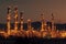 Oil refinery plant for crude oil industry on desert in evening twilight