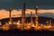 Oil refinery plant for crude oil industry on desert in evening twilight, energy industrial machine for petroleum gas