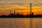 Oil refinery silhouette along the river at sunrise time