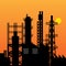 Oil refinery silhouette at sunset