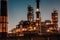 Oil refining plant at night with lights. Steel pipelines and chimneys. Petroleum and energy industry production concept