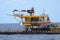 Oil rig being tugged in the sea. New oil and gas platform installed in the middle of the sea with cloudy sky.background.