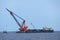 Oil rig being tugged in the sea. New oil and gas platform installed in the middle of the sea with cloudy sky.background.