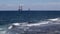 Oil rigs at sea, seen from the shore