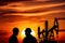 Oil rigs and silhouettes of people at sunset. Generative AI