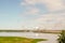 Oil sands refinery industry landscape with a lake in the front