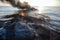 oil spill disaster on the open sea, with burning oil slicks and floating debris