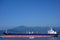 Oil tanker and a coast guard vessel in Batumi oil terminal on a sunny summer day.