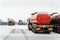 An oil tanker truck with a semitrailer-tanker truck drives through the checkpoint from the territory of the motor transport base