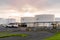 Oil tanks in a port under cloudy sky at sunset