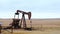 Oil Well Pump Jack pumping crude oil for fossil fuel energy. American Petroleum Oil and Gas Industry equipment extracting from a