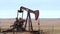 Oil Well Pump Jack pumping crude oil for fossil fuel energy. American Petroleum Oil and Gas Industry equipment extracting from a