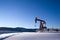 Oil well pumpjack mountain snow