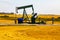 Oil well pumpjack in rural landscape