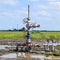 Oil well after repair in mud and puddles