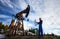 Oil worker standing by oil well pump jack.