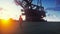 Oil worker walks on an oil platform at sunrise. 3D Rendering