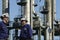 Oil workers in front of oil and fuel towers