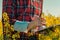 Oilseed rape farmer writing notes on clipboard notepad in blooming field