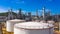 Oilâ€‹ refineryâ€‹ andâ€‹ petrochemicalâ€‹ plant industrial working with fire and blue sky background, Aerial view oil and gas