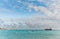 OISTINS, BARBADOS - MARCH 15, 2014: Miami Beach Landscape with Ocean Water Blue Sky and Oil Chemical Tanker with Boats.