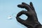 OK sign. Hand in black latex glove. Virus protection or cosmetics concept. Clear diagnostic test, recovery