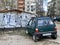 OKA Mini Car Parked by the Typical Residential Buildings in Provincial Russia