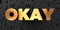 Okay - Gold text on black background - 3D rendered royalty free stock picture