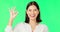 Okay hands, face and happy woman on green screen, background and studio in praise of support. Portrait of female model