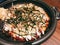 Okonomiyaki - traditional Japanese hot plate pizza with copyspace. Dark tone