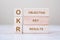 OKR text Objectives, Key and Results wooden cube blocks on table background. business target and focus concepts