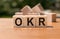 OKR word written on wood block. Abbreviation of Objective Key Results