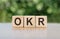 OKR word written on wood block, abbreviation of Objective Key Results