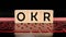 OKR word written on wood block. abbreviation of Objective Key Results text for your desing