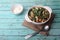 Okroshka - cold vegetable soup - in a bowl on blue wooden background