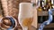 Oktoberfest beer. Foamy beer is poured into a glass and the decor of the oktober fest in germany. And Bretzel -